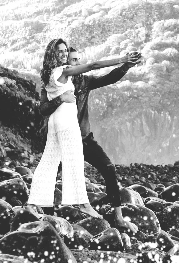 Rytis and Violeta together on wet shoreline rocks