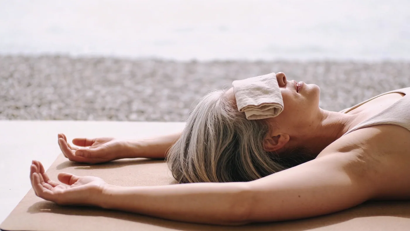 Person walking a clear gravel path on overcast day, body relaxed, returning to non dual awareness after confusion