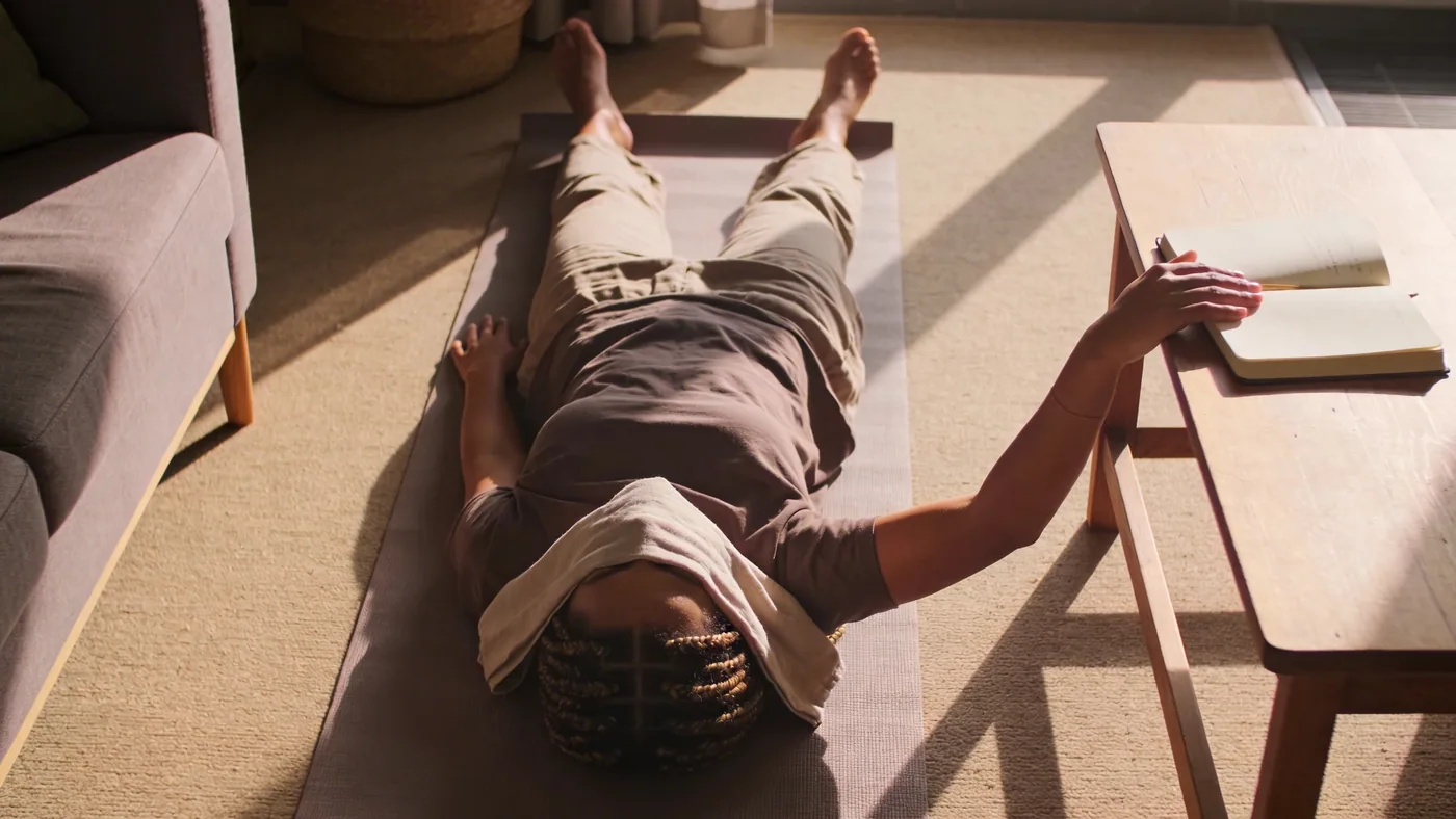 Relaxed hands resting on wooden table beside open journal showing what shifts after emotional safety practice — feeling emotionally unsafe