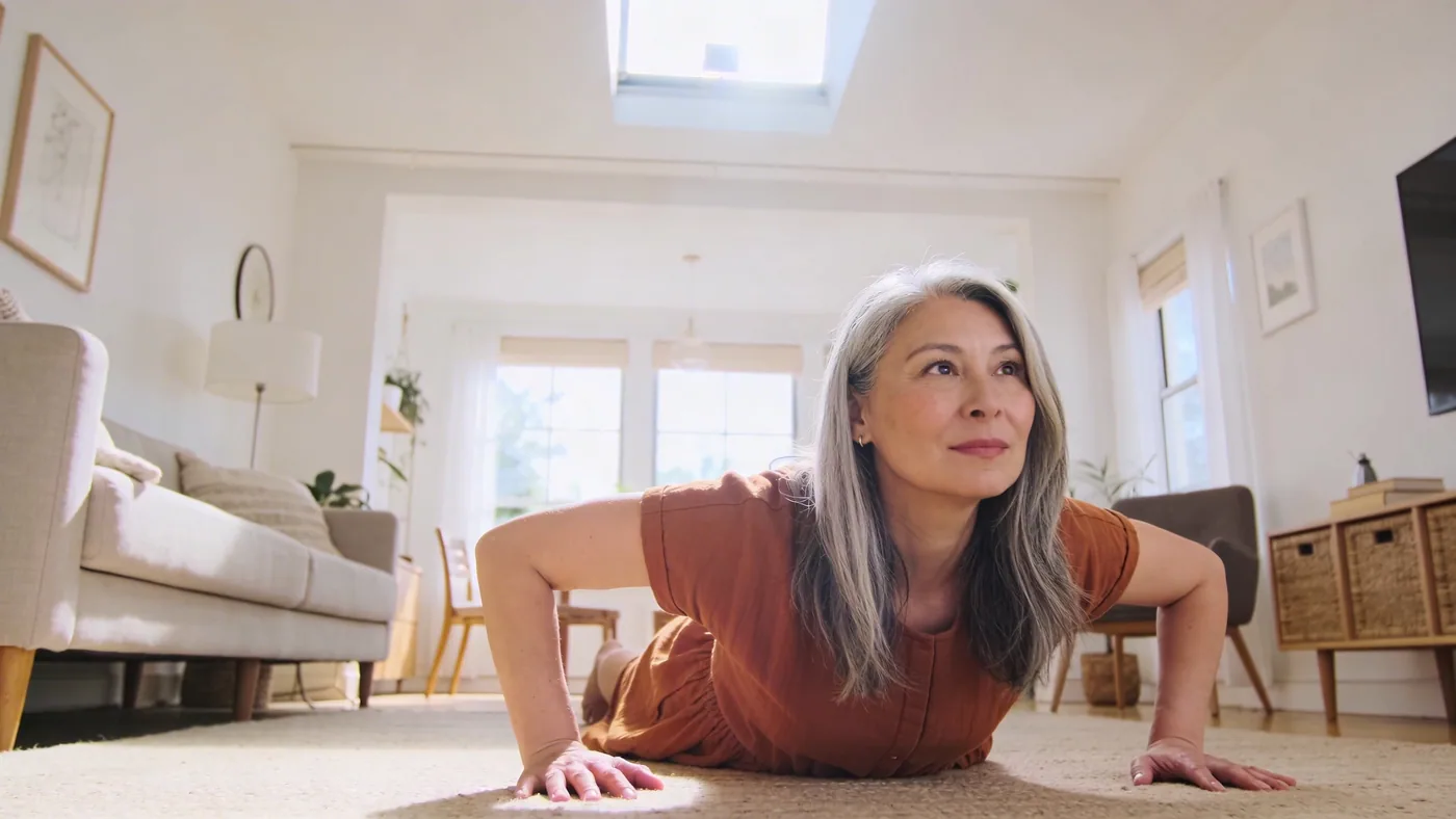Woman lying on living room floor with palms down during a 12-minute reset for feeling emotionally unsafe