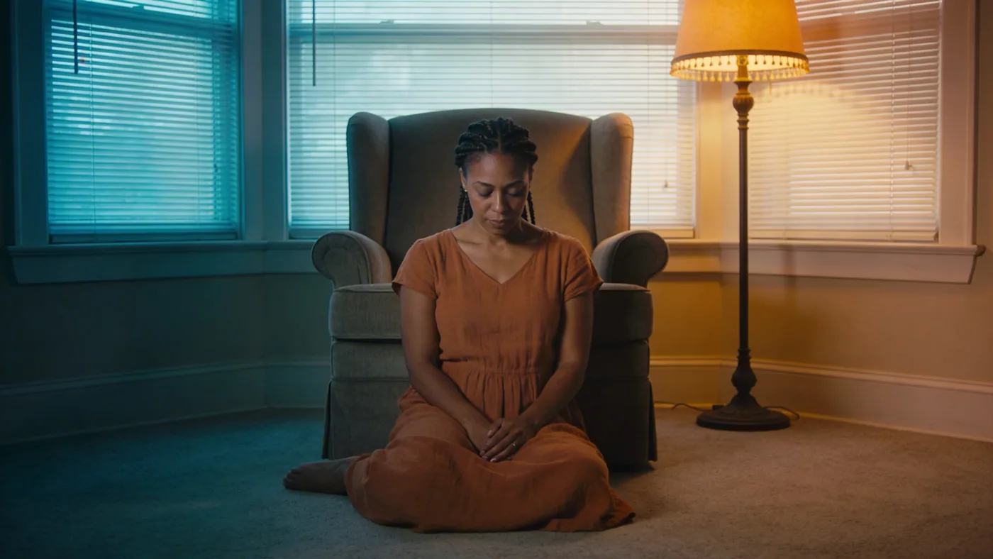 Woman lying on wooden floor in Feeling Session posture with eyes covered exploring what emotional manipulation is through body awareness — what is emotional manipulation