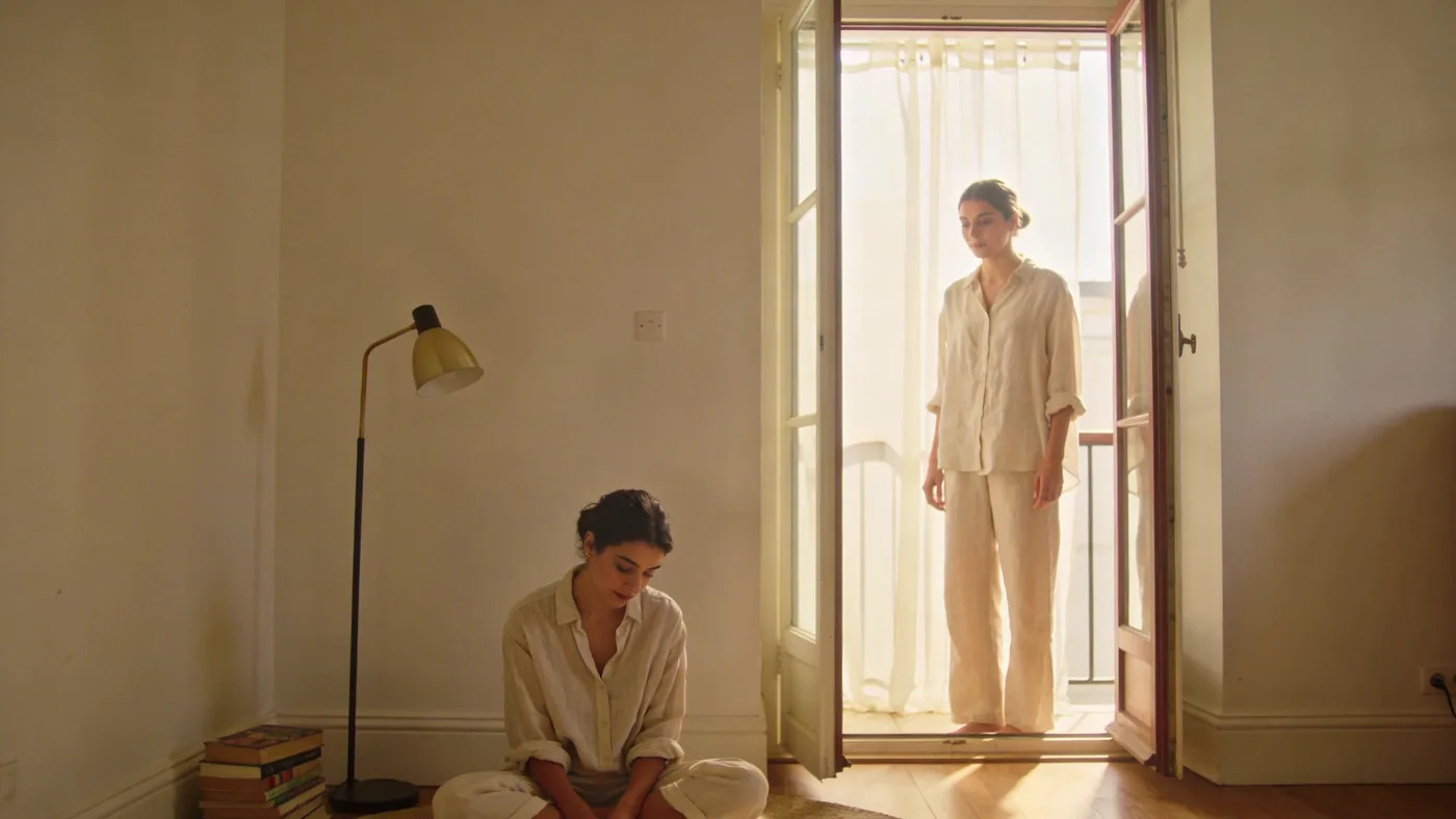 Woman standing at open balcony door in soft light illustrating why you can't think your way through grief — stages of grief breakup