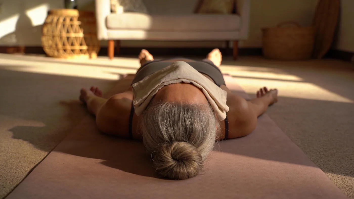 Woman walking through crowded market with body braced showing why decisions get harder under activation — difference between ego and higher self