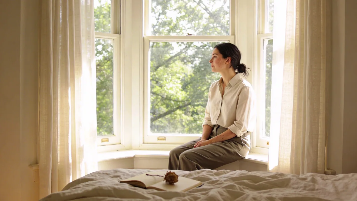 Worn journal with dried flower on rumpled bed in morning light after shadow work practice changes — what is shadow work spirituality