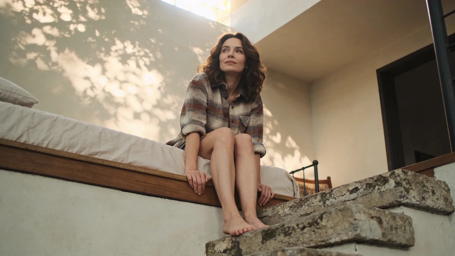 Bare feet paused on weathered stone steps symbolizing awakening symptoms moving through the body