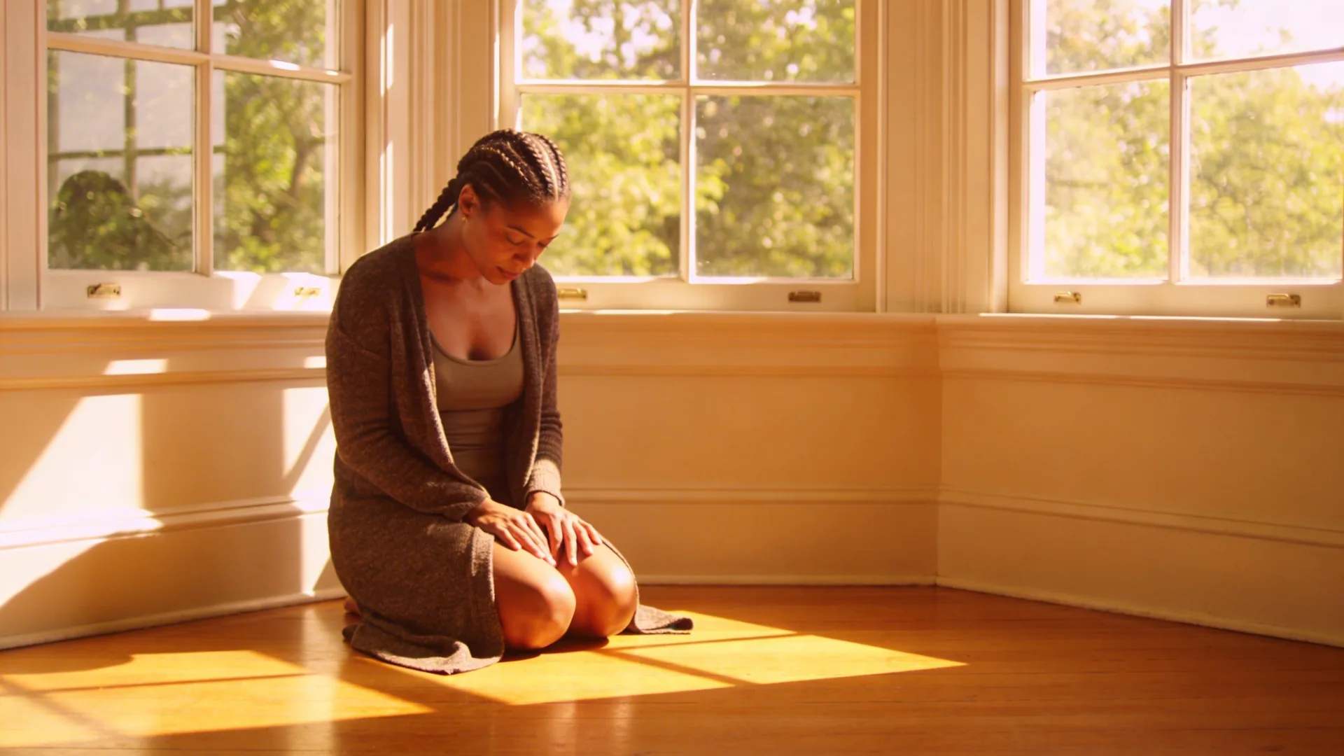 Man lying in Feeling Session posture on wooden floor with eyes covered breaking the anxiety nausea loop