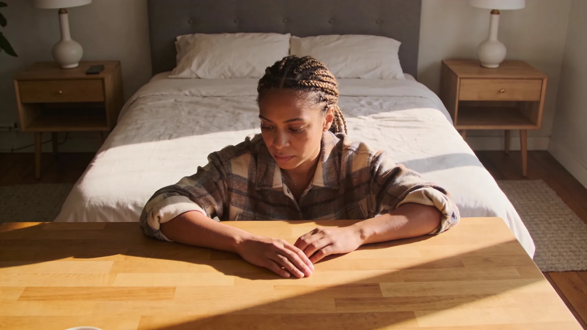Relaxed hands resting on wooden kitchen table showing what changes after this practice of body awareness