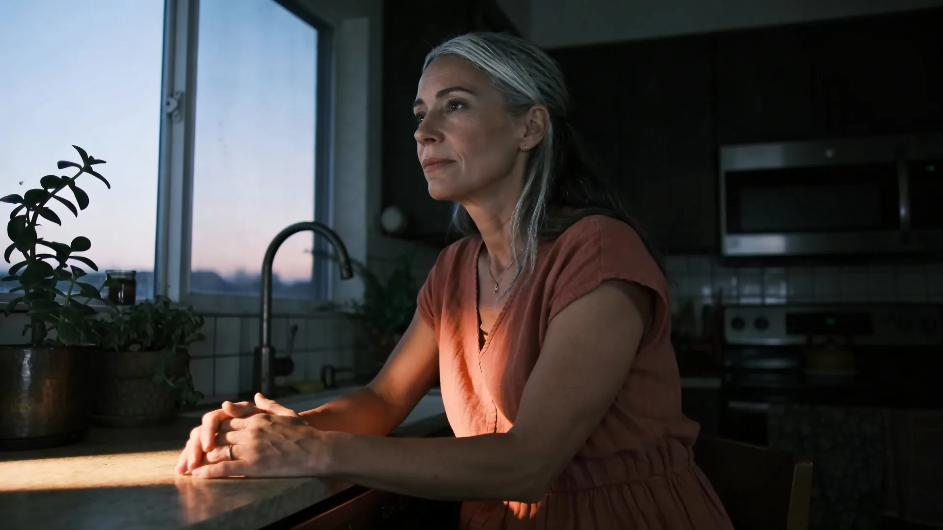 Close-up of hands and chest showing held breath on kitchen counter during intuition vs ego recognition