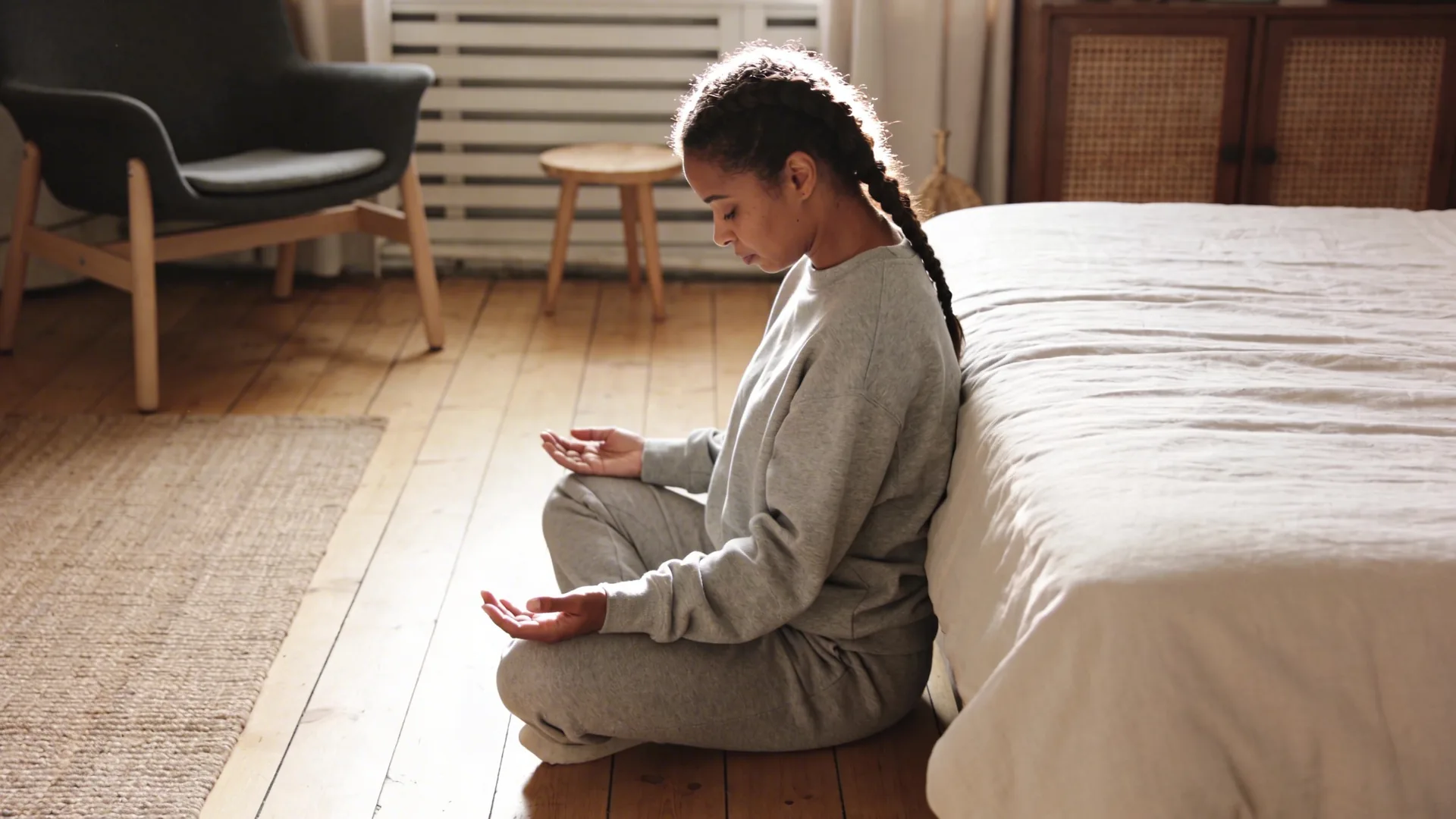 Person lying on wooden floor in Feeling Session posture with palms down integrating after ego death intensity
