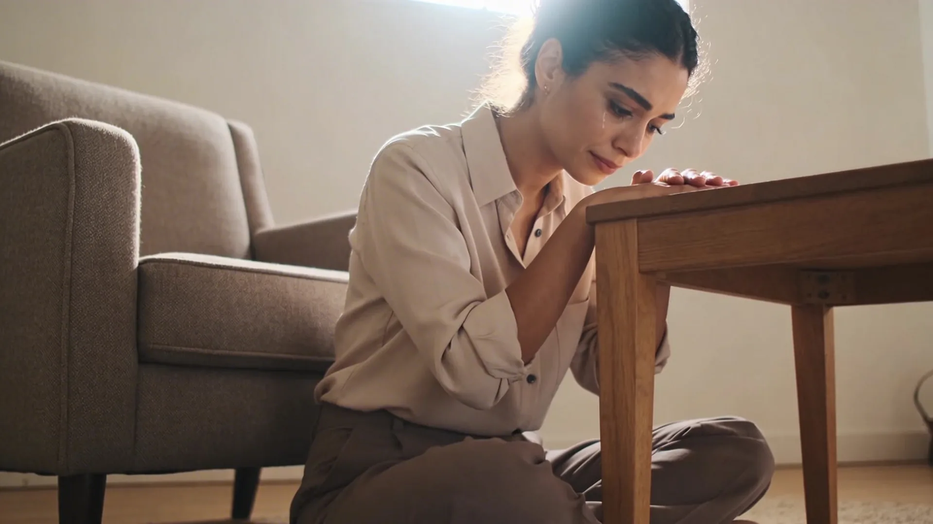 Hands resting palms down on wooden table as a calm 10-minute reset when emotional invalidation hits