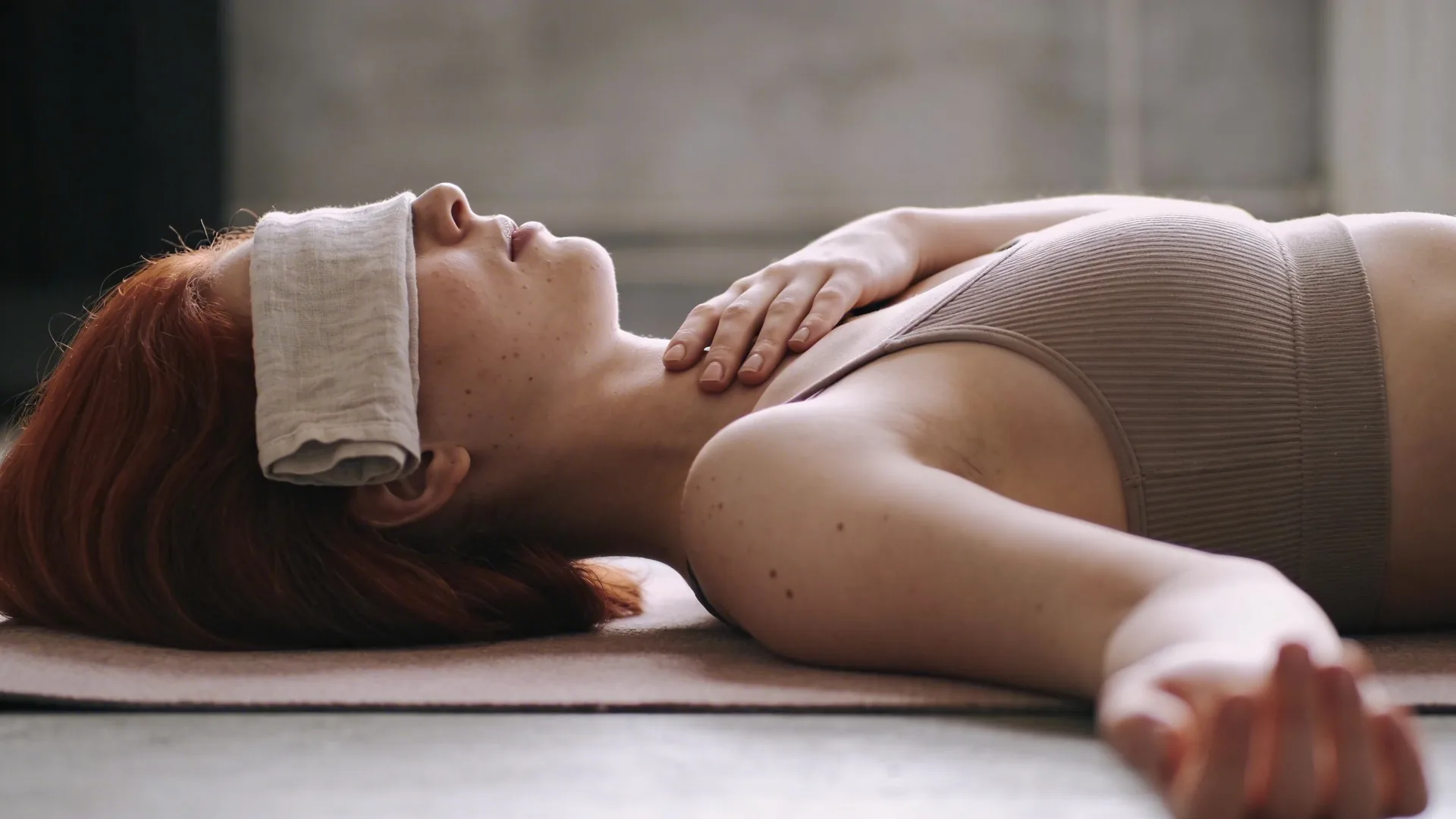 Close-up of hand resting on collarbone near throat showing emotional validation examples through body awareness