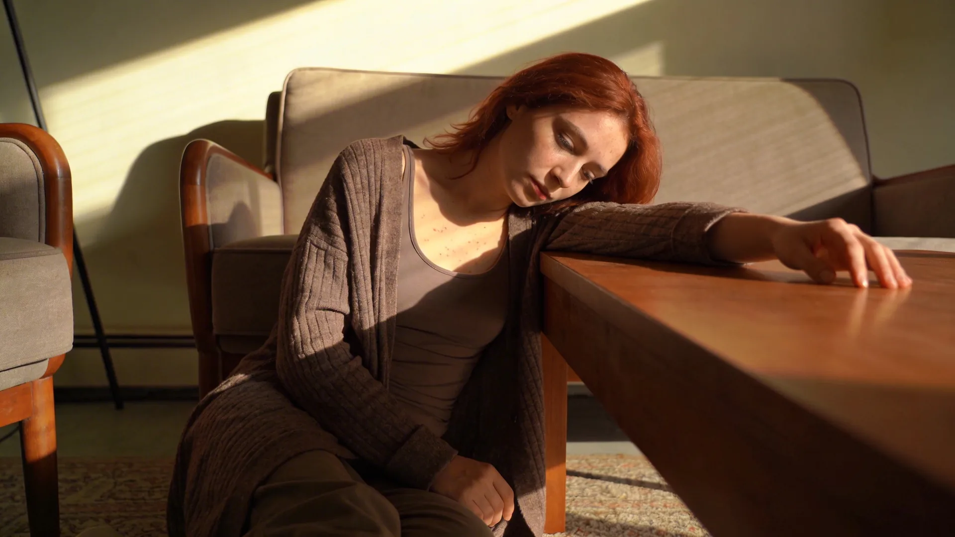 Woman standing in a doorway between shadow and light illustrating why examples of shadow work matter more than theory