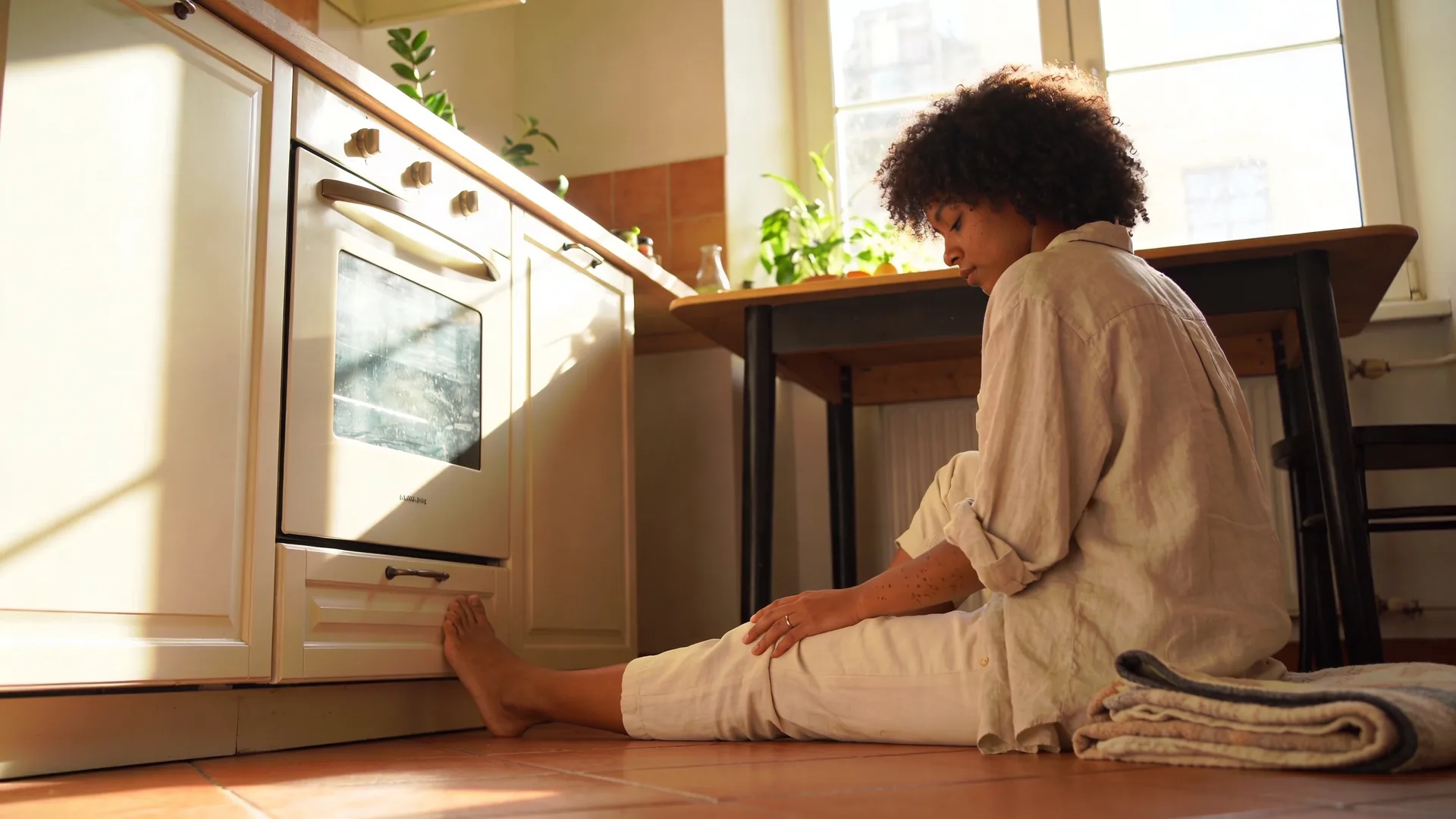 Bare feet resting on terracotta floor beside folded blanket for a 12-minute burnout reset