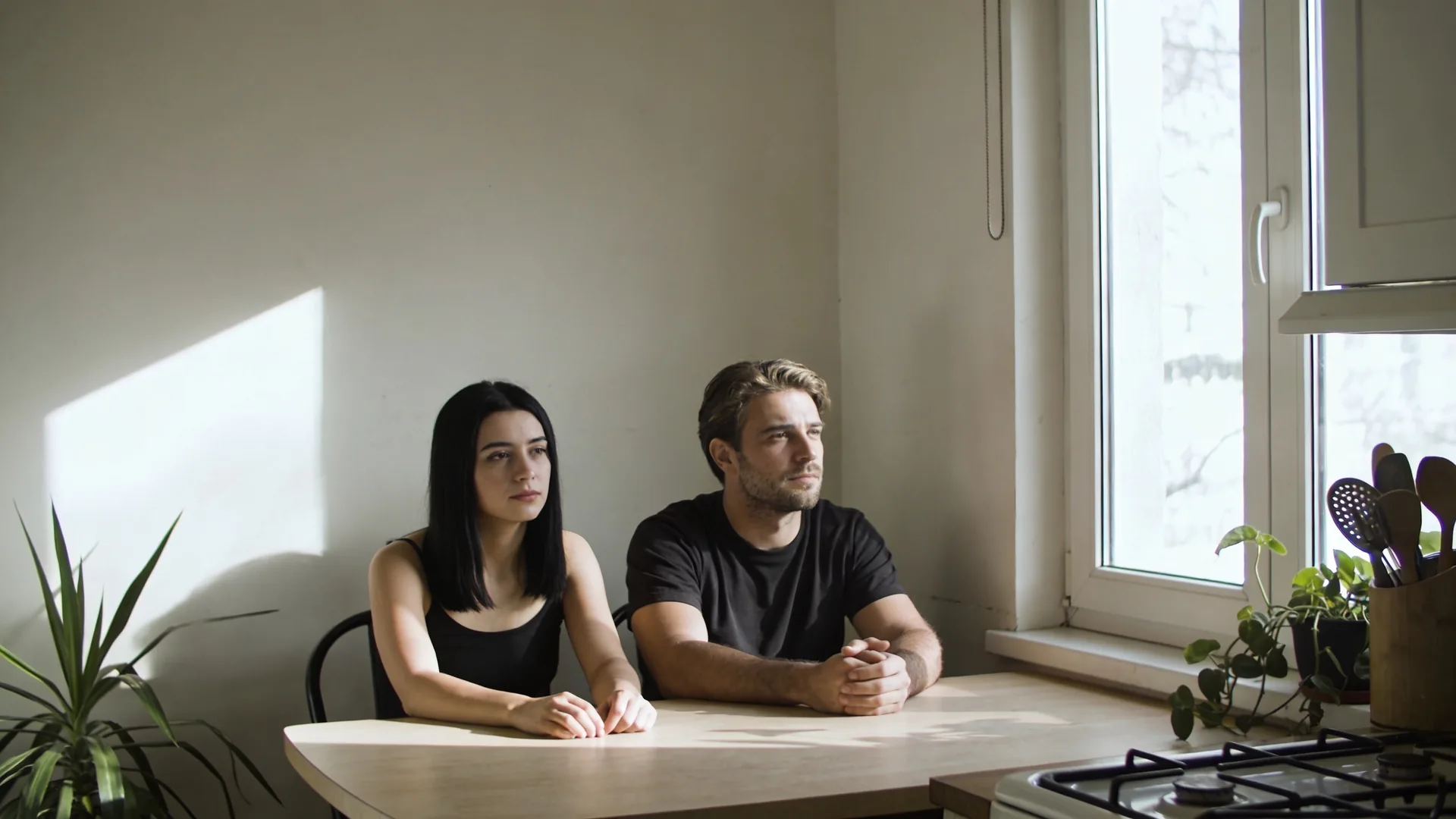 Couple standing apart in sunlit kitchen illustrating [how to build emotional intimacy](/emotional-safety/how-to-build-emotional-intimacy/) through honest conversation