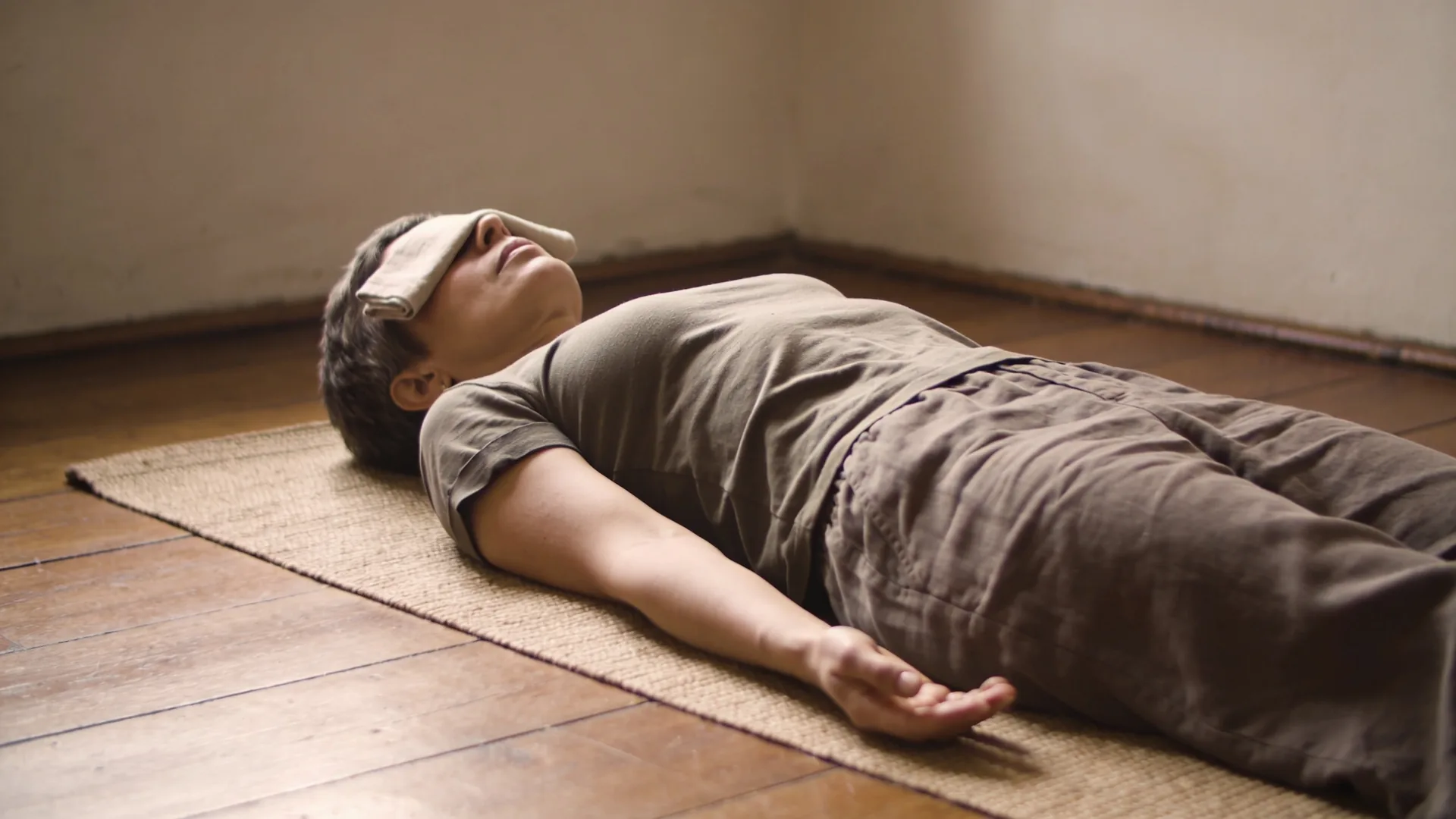 Person leaning back on wooden porch steps with eyes closed and open chest, embodying permission over pressure in the body