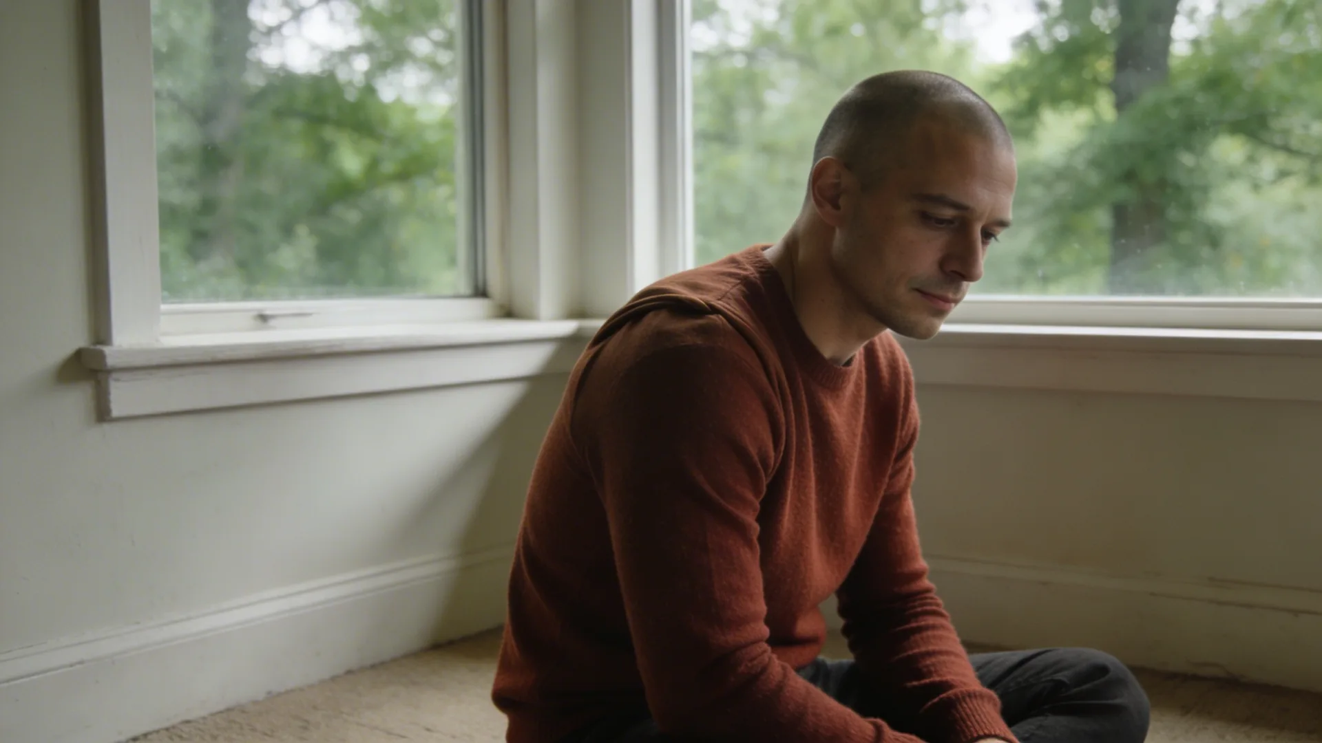 Man gripping kitchen counter with tense shoulders showing how to let go of anger and resentment held in the body