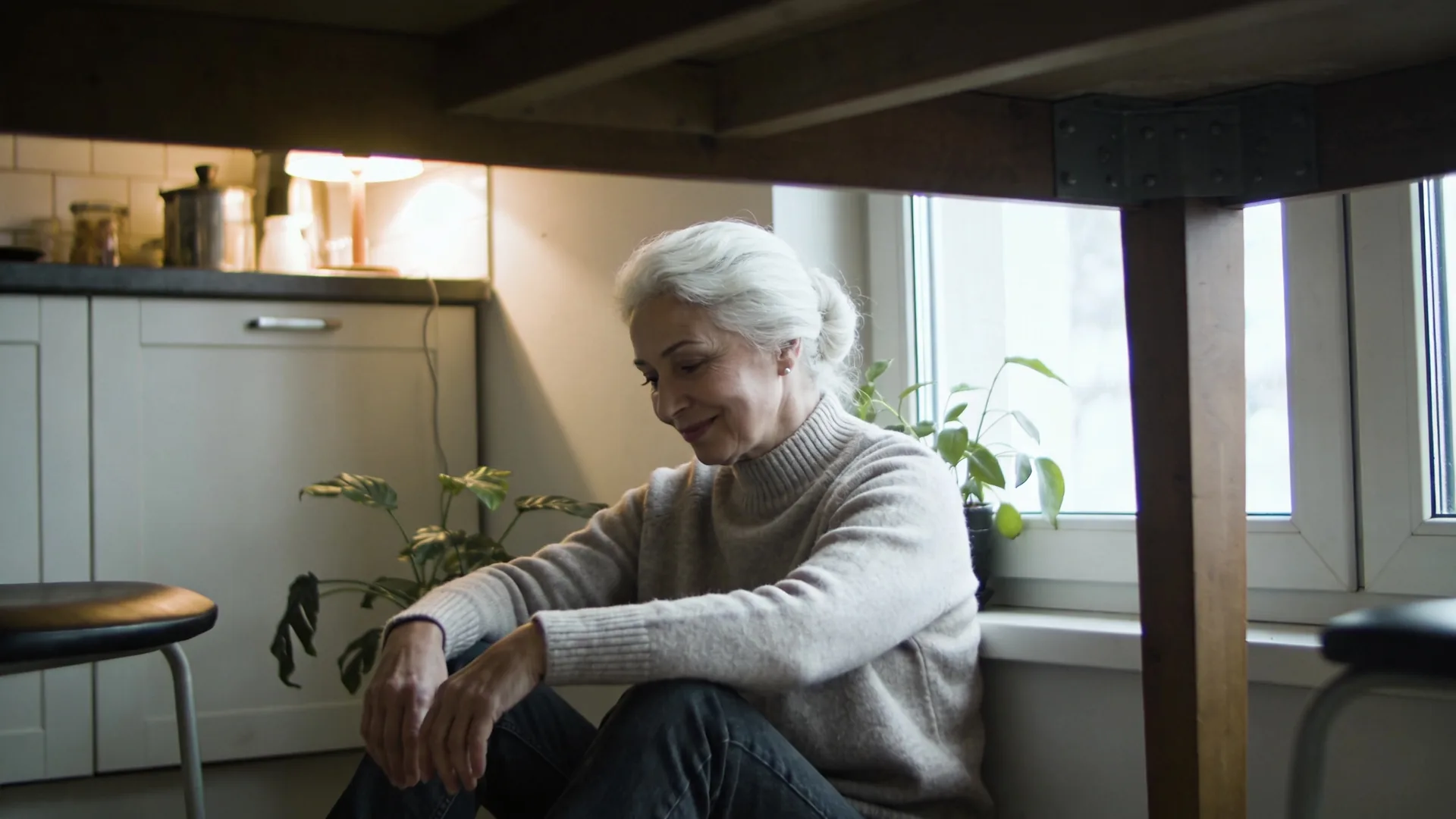 Woman sitting quietly on bed edge in morning light, learning how to stop overthinking