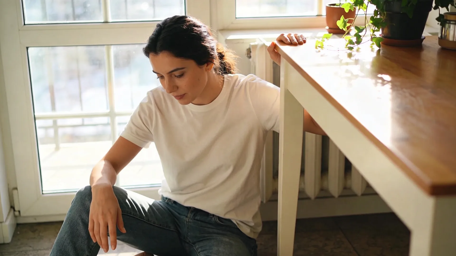 Hands resting on a ceramic bowl on a wooden table, holding space when shame numbness or doubt shows up