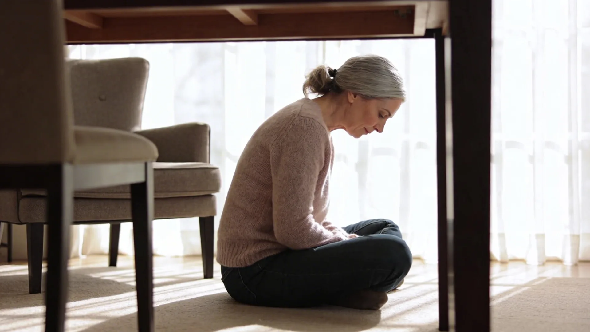 Woman with rigid back posture bracing at desk showing the trap that keeps burnout recovery shallow