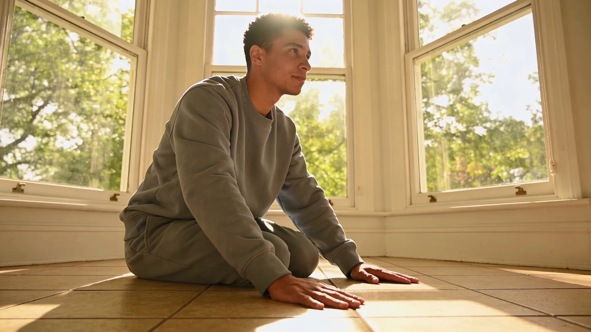 Hands pressing firmly into ceramic floor tiles as a grounding technique during a somatic eating urge