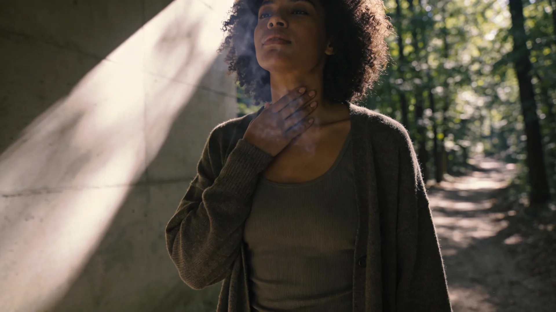 Close-up of tense throat and hovering hand catching unspoken words, recognizing spiritual bypassing examples