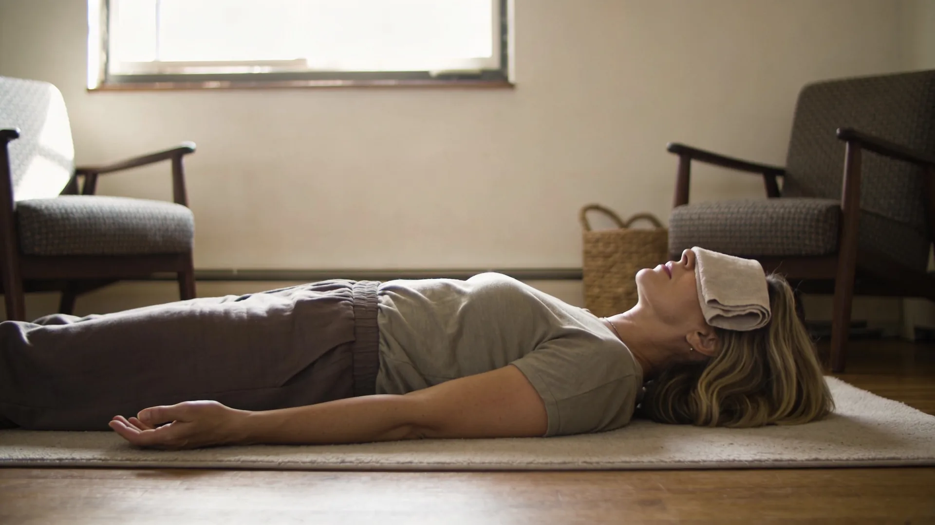 Woman lying on floor with palms down practicing body-based shadow work when journaling stops moving anything
