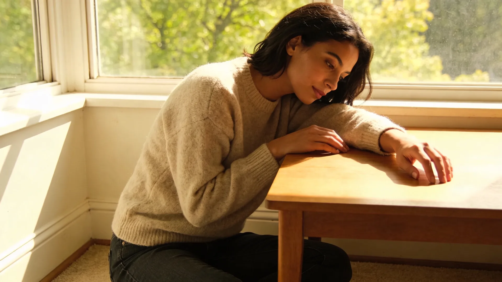 Relaxed hands resting beside a handmade ceramic bowl on a wooden table recognizing the signs of complicated grief in daily life