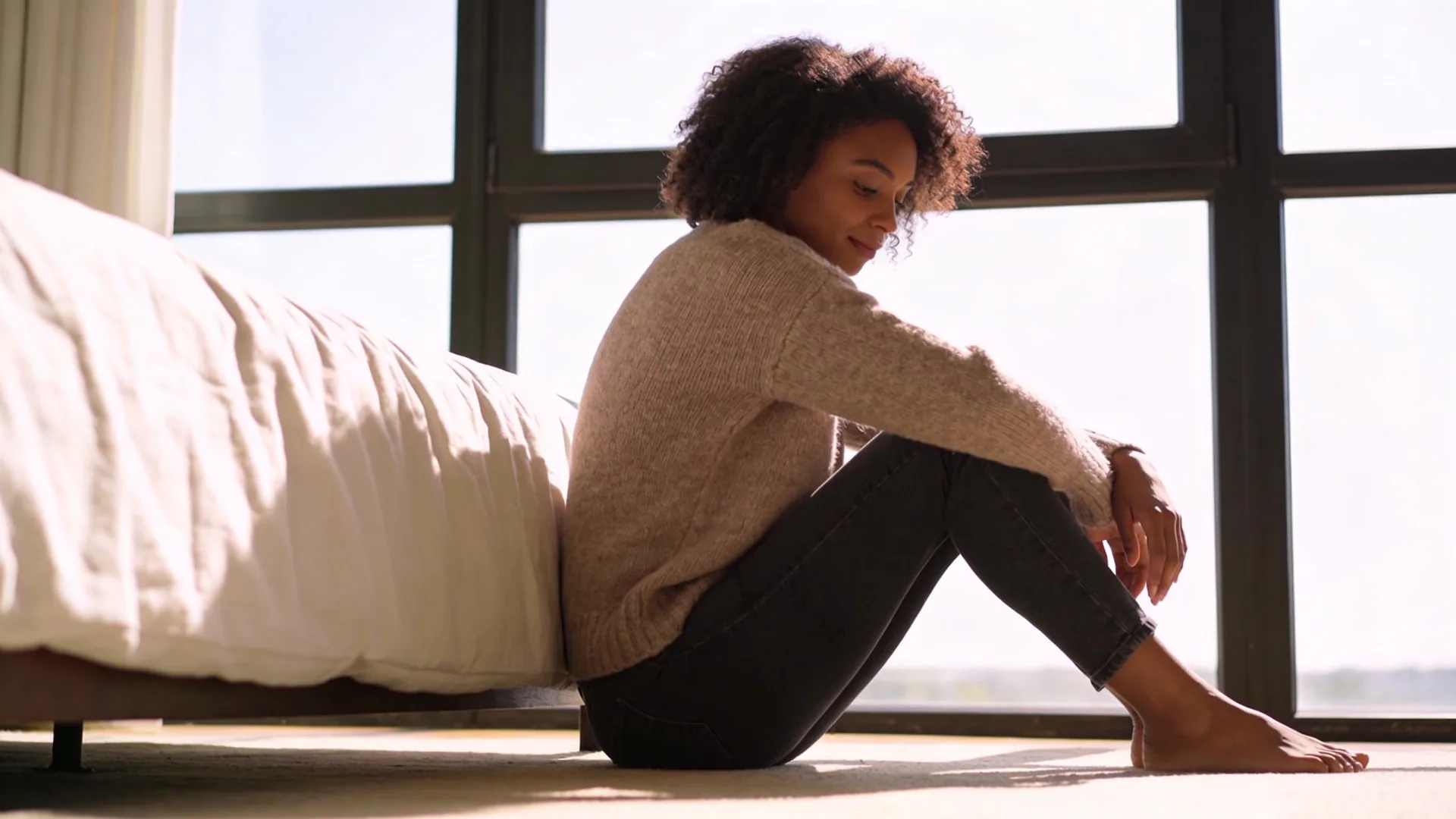 Woman lying on living room floor palms down practicing a 12-minute body return for the dark night of the soul