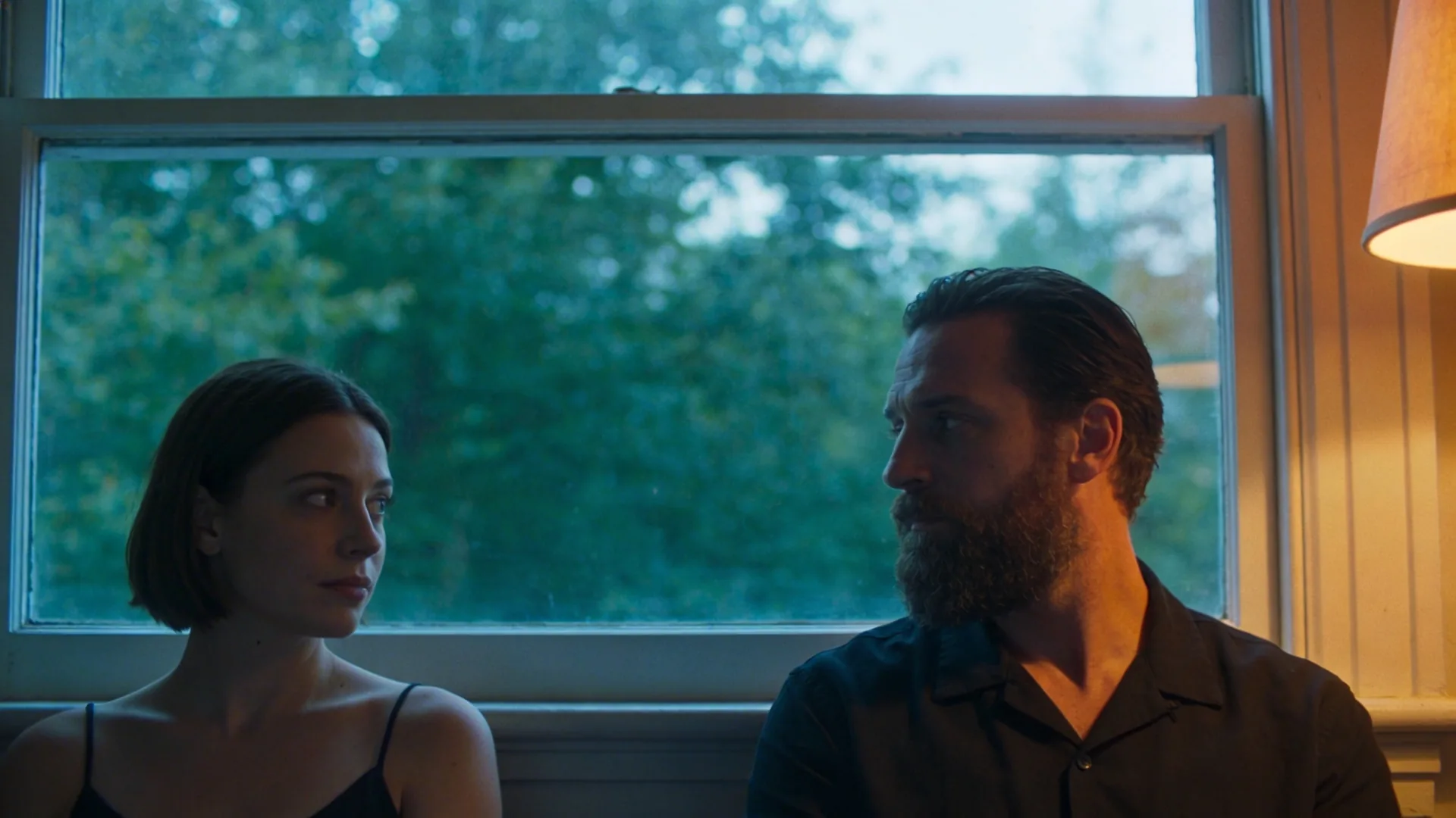 Two people sharing quiet stillness in a hallway as fear eases and what actually shifts becomes visible