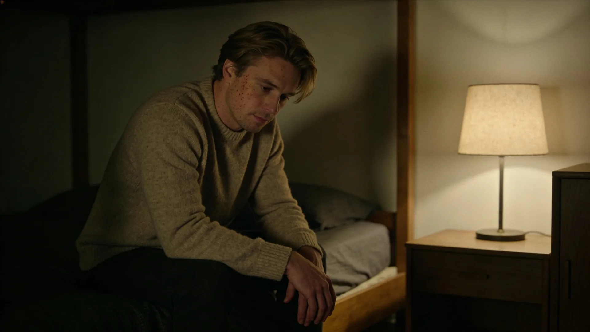 Why cant i open up to anyone — seated on the edge of a bed, forearms on thighs, hands clasped, soft evening lamp, why cant i open up
